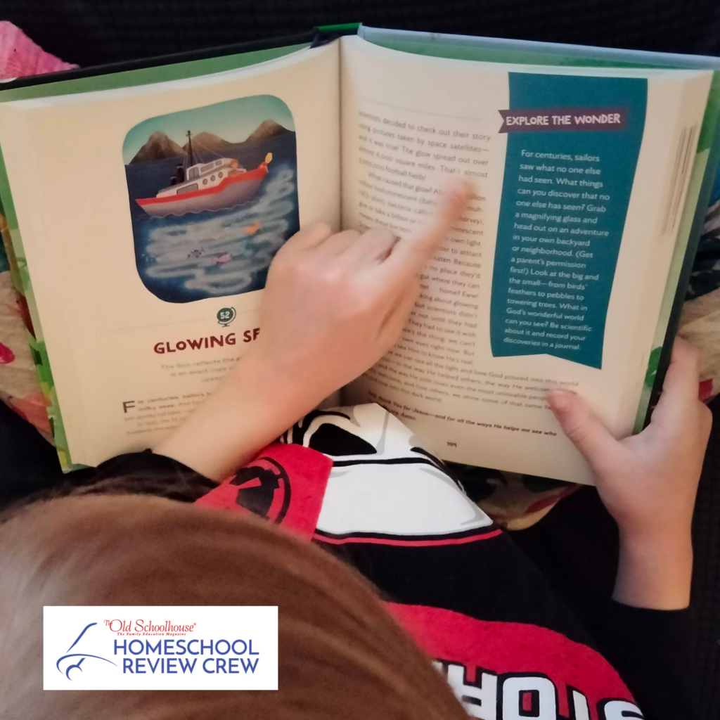Child looking at a page of The Wonder of Creation Devotional for Children