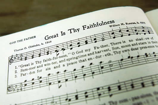 Picture of a hymn book open on the page with the hymn Great is Thy Faithfulness.